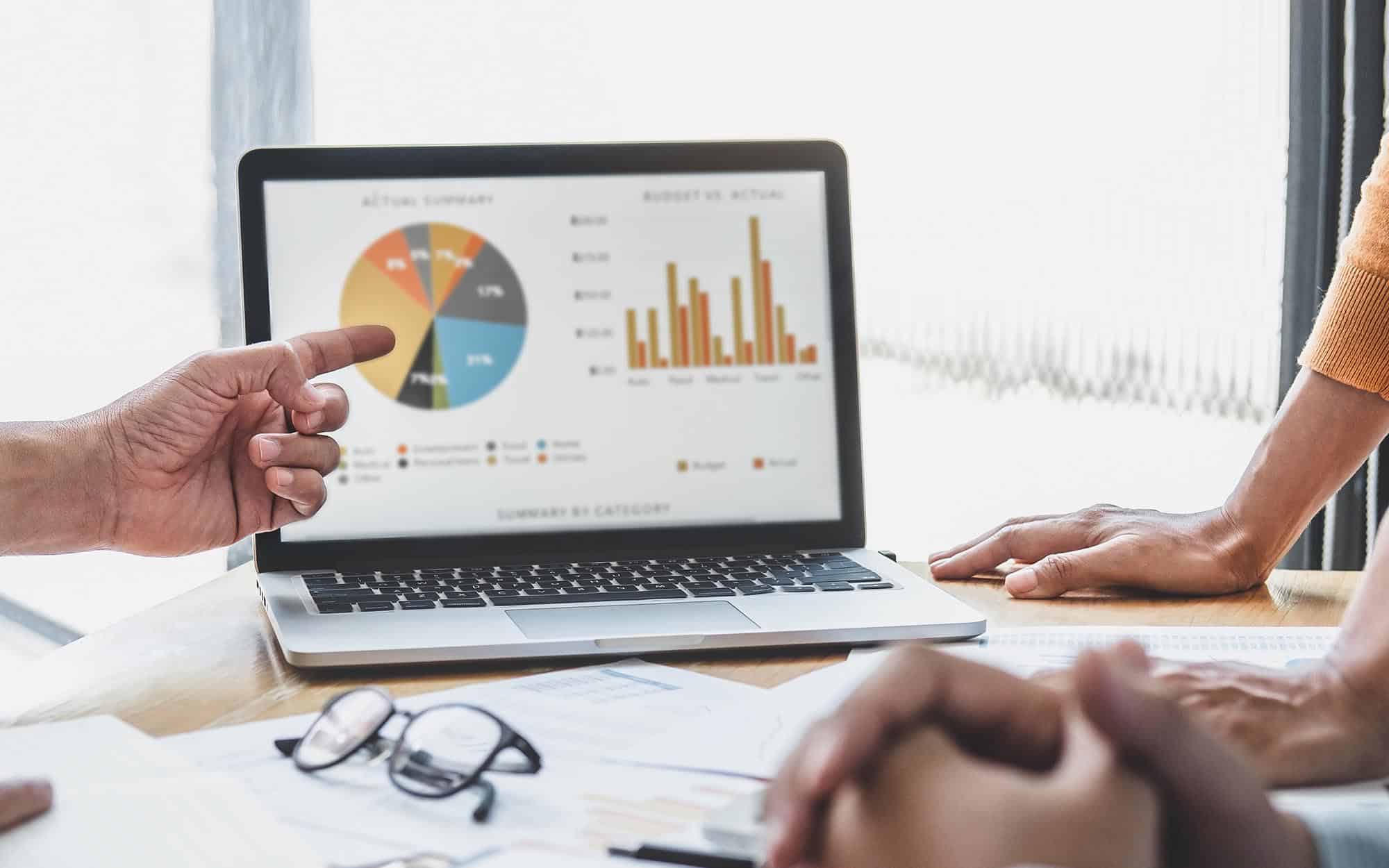 People meeting to analyze data on laptop