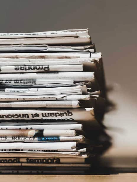 stack of printed publications on pr firm desk