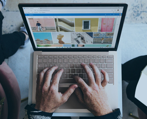 pr agency team members showing web design on laptop in firm's office