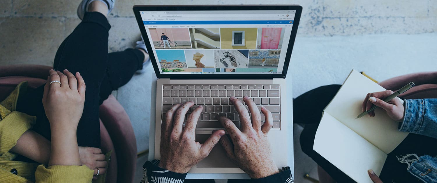 pr agency team members showing web design on laptop in firm's office