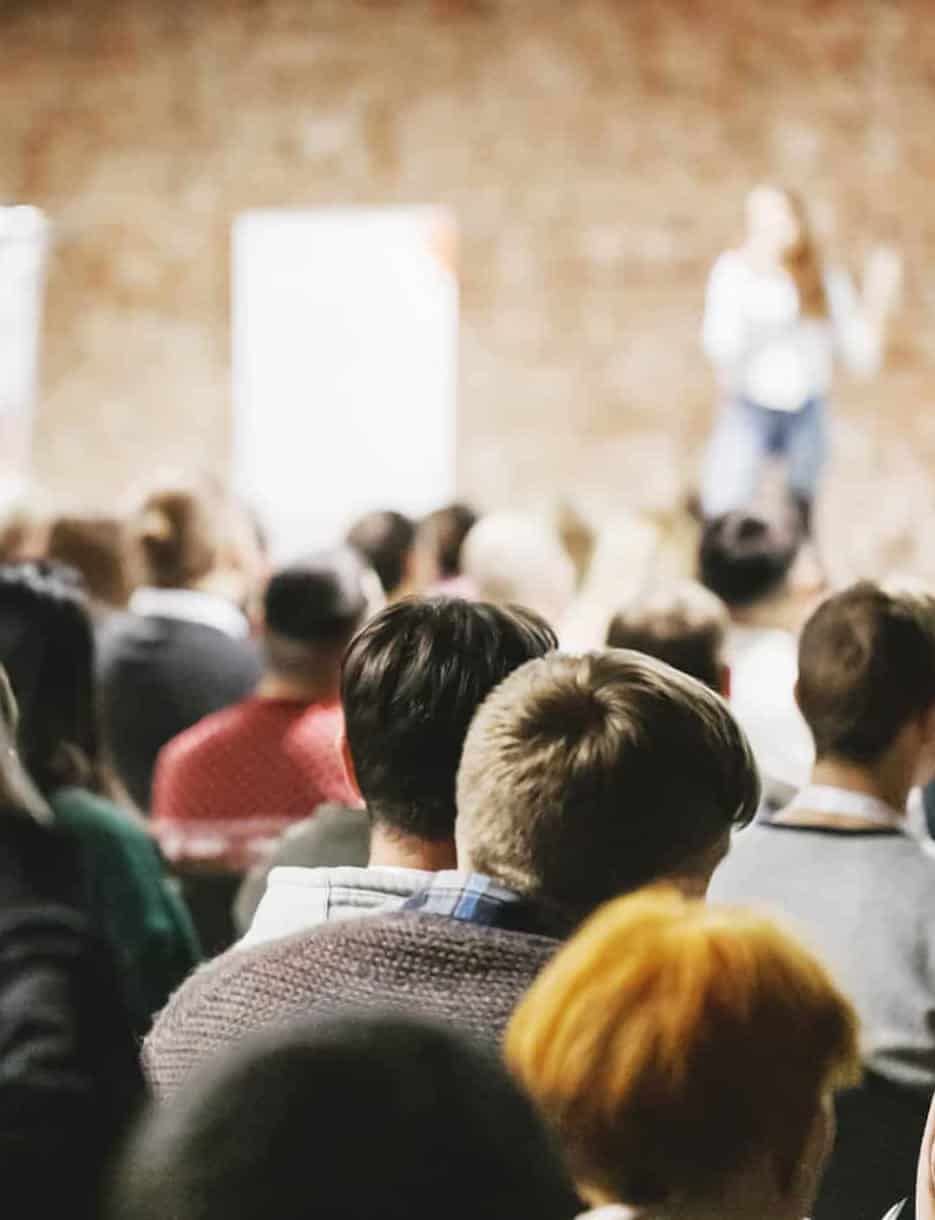 stacey bender giving a pr brand presentation in auditorium