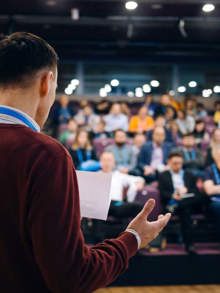 corporate presentation pr event with man presenting to audience