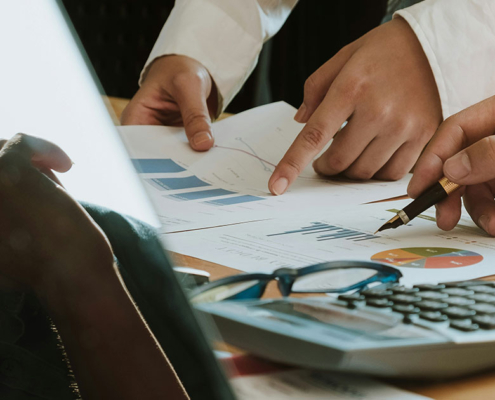 pr professionals looking through marketing analytics on paper together