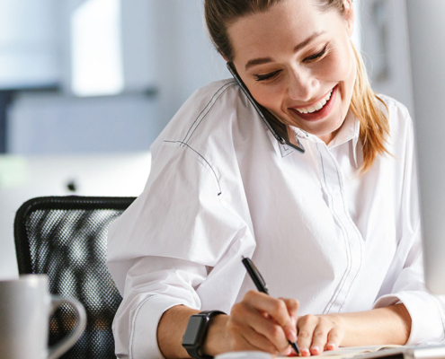 pr expert on phone taking notes about an earned media at agency