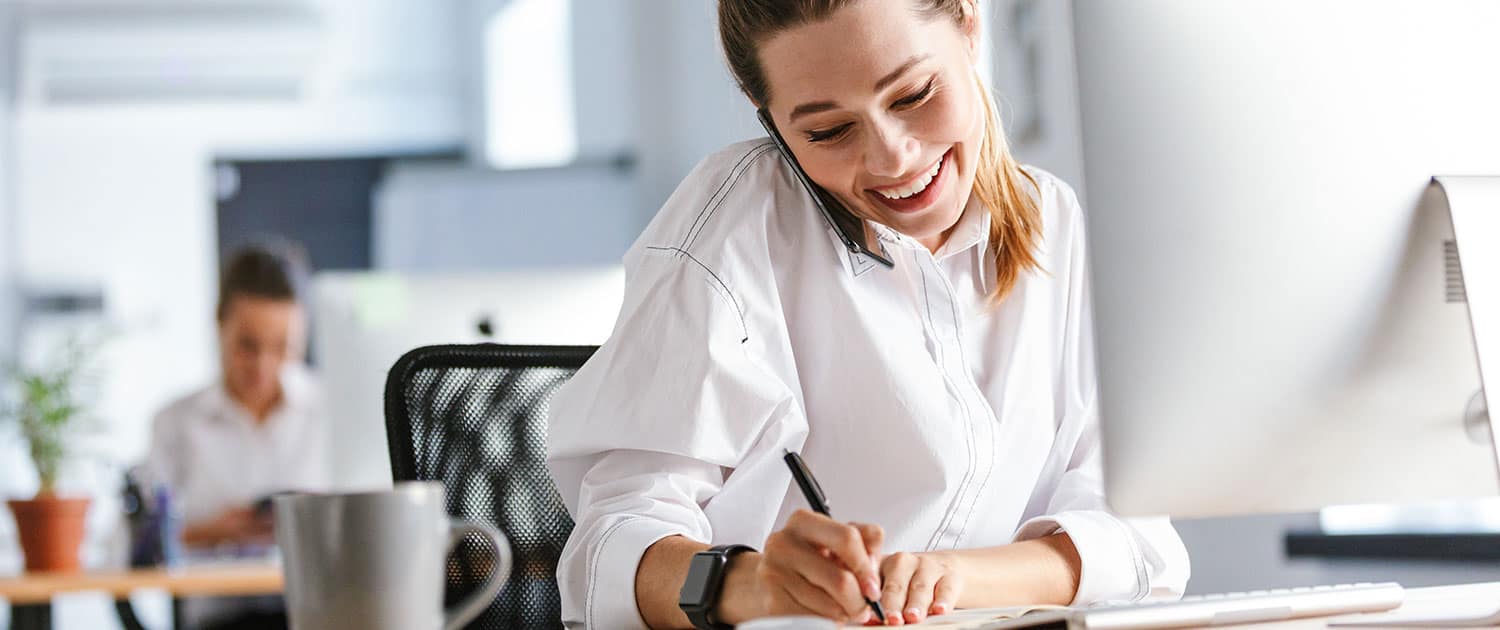 pr expert on phone taking notes about an earned media at agency
