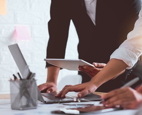 journalists in modern office working on pr strategy at computer