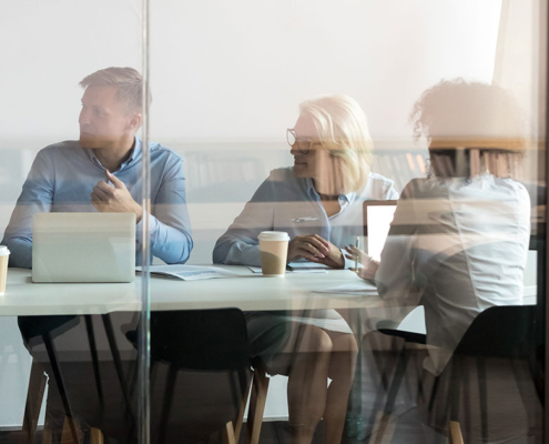 pr team in conference room meeting on a media pitch campaign for a client