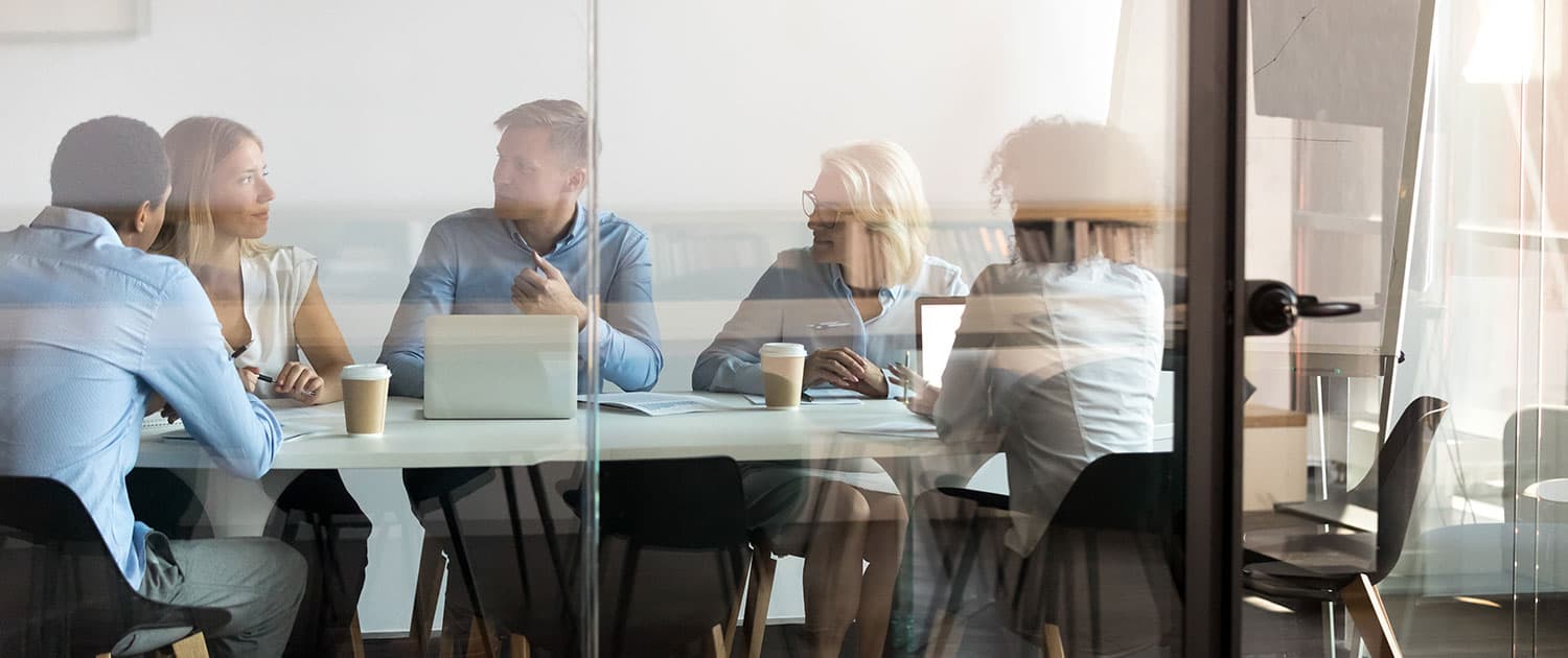 pr team in conference room meeting on a media pitch campaign for a client