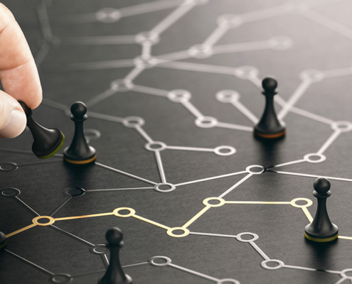 person moving pawn chess pieces on table with marketing points