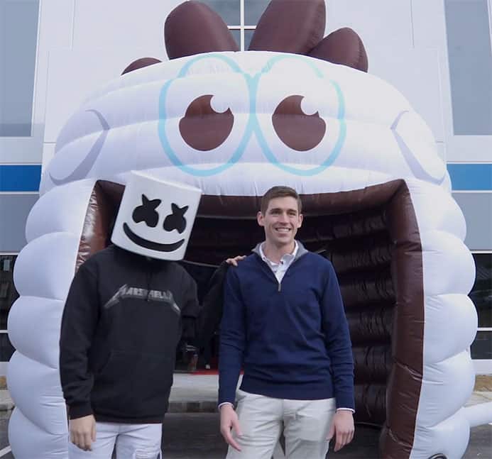 DJ Marshmellow and founder of stuffed puffs marshmallows in front of large inflatable marshmallow mascot