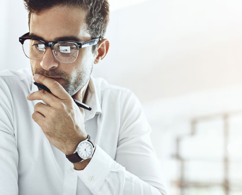 publisher looking at laptop in bright pr agency office
