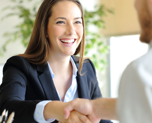 pr firm strategist shaking hands with new client at agency office