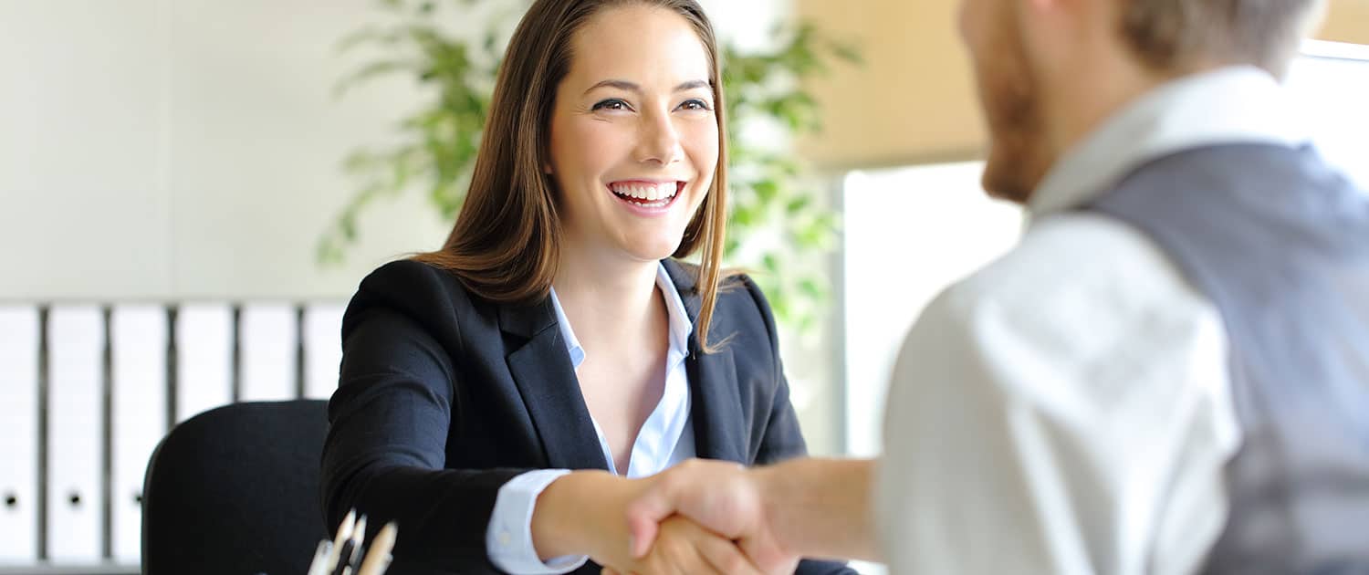 pr firm strategist shaking hands with new client at agency office