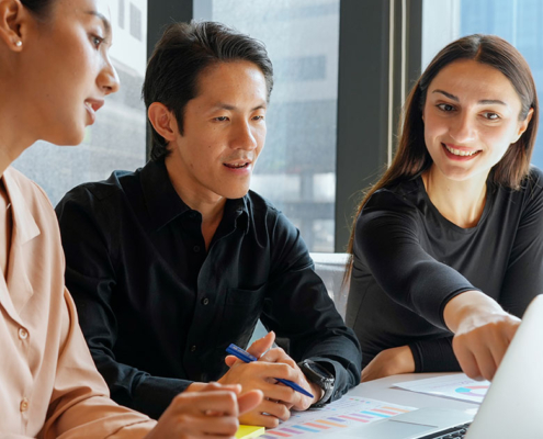 pr firm employees working on relations firm numbers at desk